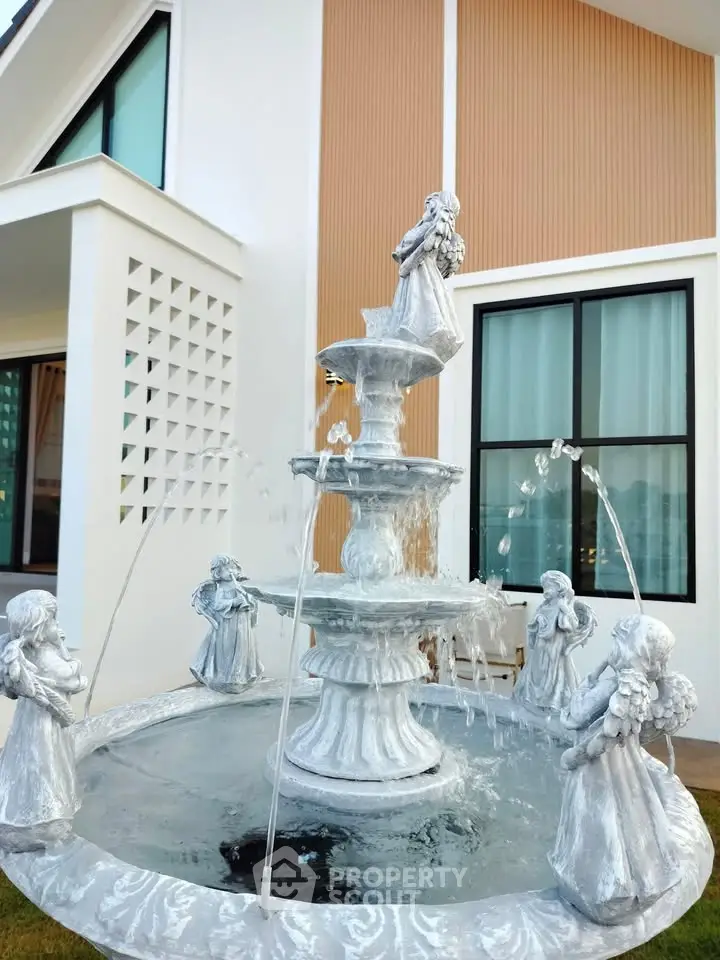 Elegant modern home exterior with decorative fountain and stylish architecture