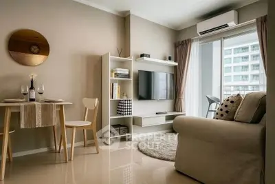 Modern living room with cozy seating, wall-mounted TV, and dining area in a stylish apartment.