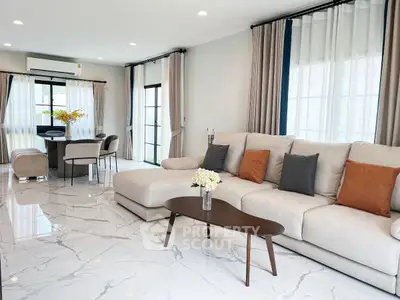 Spacious modern living room with elegant marble flooring and cozy seating area.