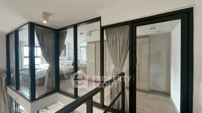 Modern duplex interior with glass walls and elegant bedroom view