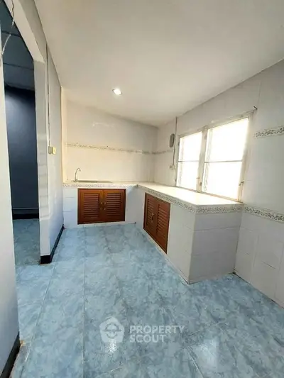 Spacious kitchen with ample natural light and tiled flooring