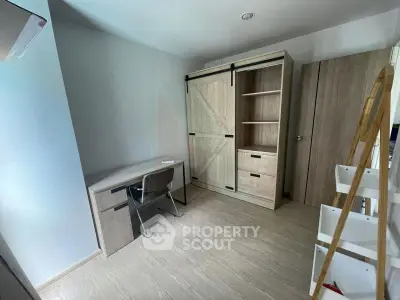 Modern study room with sleek desk and stylish wardrobe in a bright, minimalist design.
