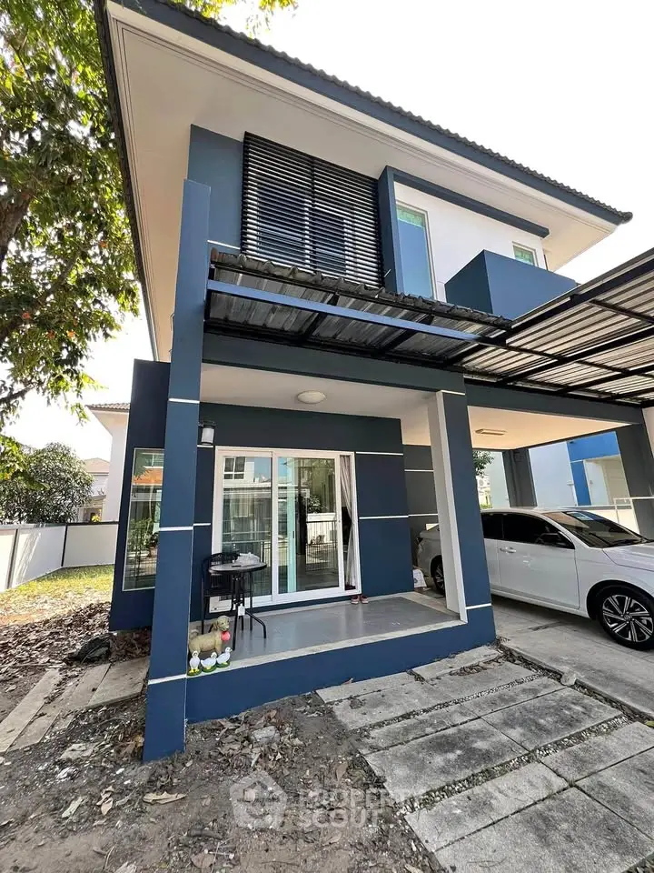 Modern two-story house with carport and sleek exterior design