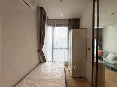 Modern bedroom with large window and city view, featuring sleek design and natural light.