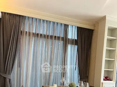 Elegant living room with large window and stylish curtains