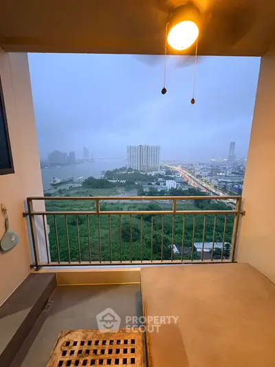 Stunning balcony view of city skyline and river at dusk, perfect for urban living.