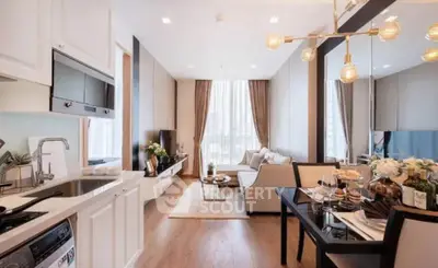 Modern open-layout living room and kitchen with elegant decor and natural light.