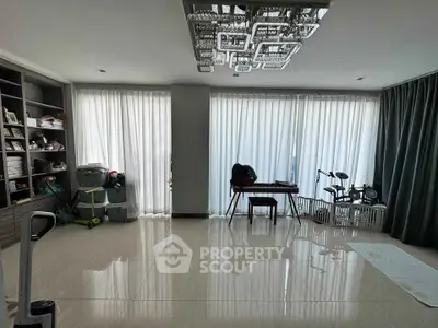 Spacious living room with modern chandelier and floor-to-ceiling windows