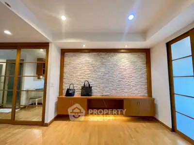 Spacious modern living room with wooden flooring and stylish wall design