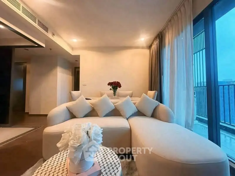 Luxurious living room with elegant decor and large windows offering stunning views.