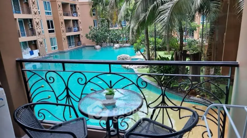 Stunning balcony view overlooking a tropical pool in a luxurious apartment complex.