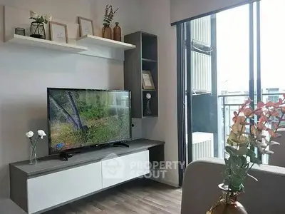 Modern living room with sleek TV unit and balcony view