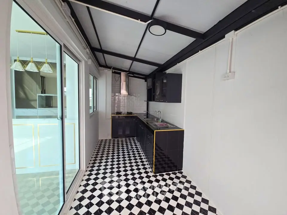 Stylish modern kitchen with black cabinets and checkered floor tiles, featuring open layout and sleek design.