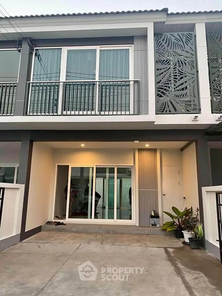 Modern townhouse exterior with stylish facade and balcony, perfect for urban living.