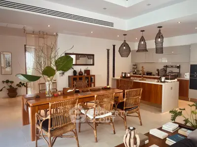 Stunning open-plan living and dining area with modern kitchen, featuring elegant wooden furniture and stylish lighting.