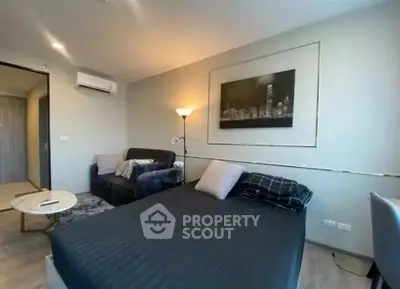 Modern bedroom with stylish decor and cozy seating area, perfect for urban living.
