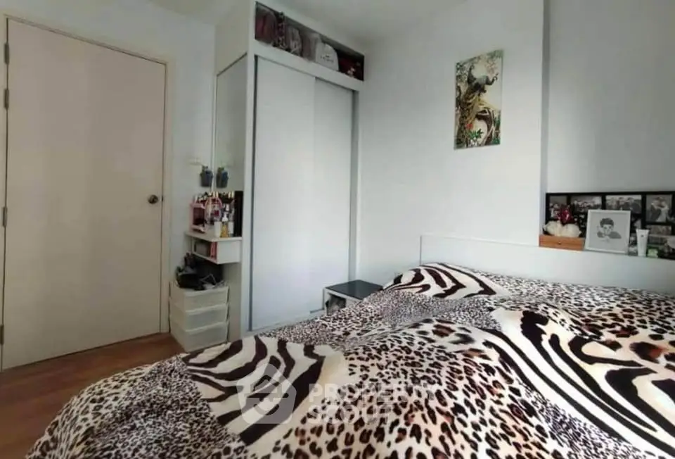 Cozy bedroom with animal print bedding and modern decor