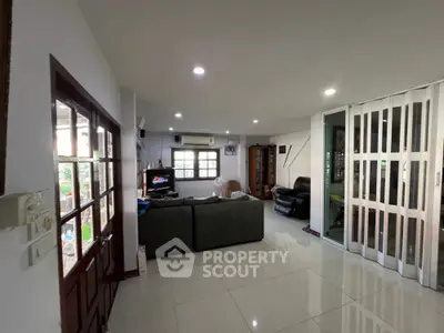 Spacious living room with modern decor and large windows for natural light