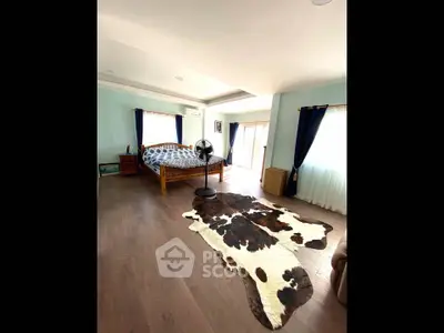 Spacious bedroom with stylish decor and natural light