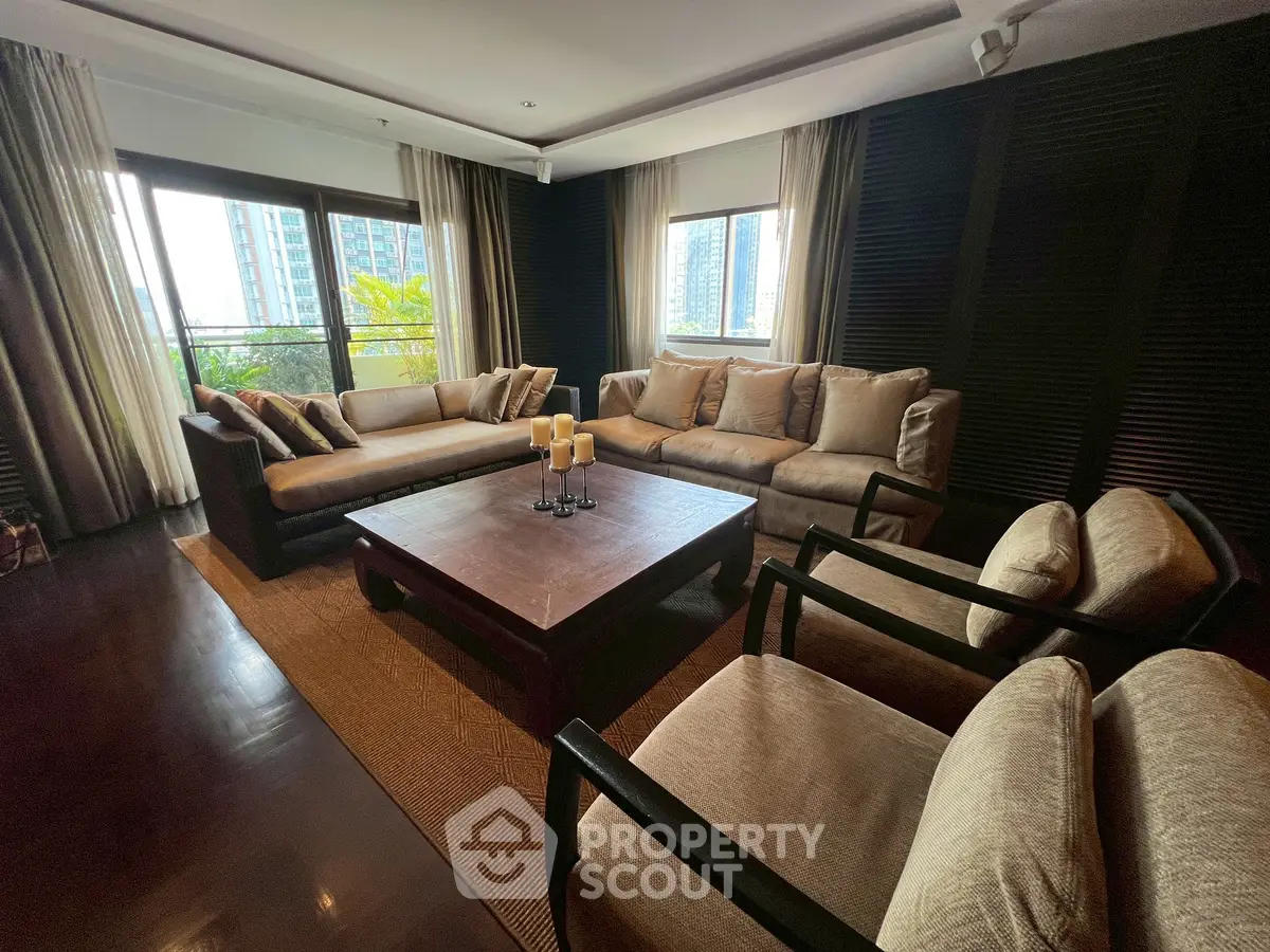 Luxurious living room with elegant furniture and large windows offering a stunning city view.
