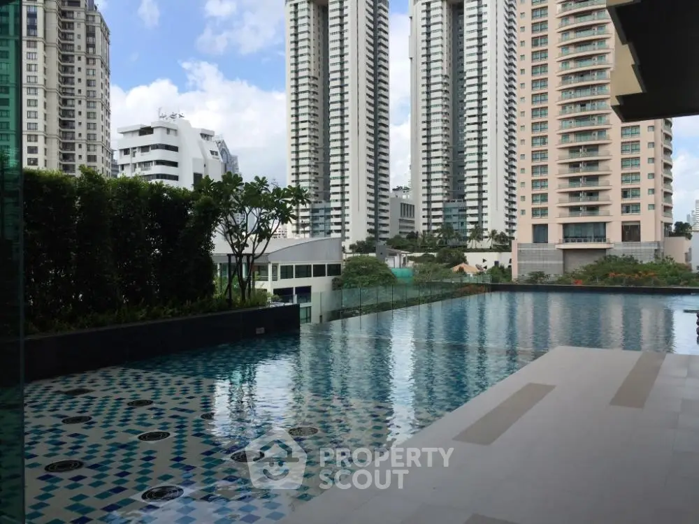 Luxurious high-rise apartment with stunning pool and city views.