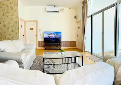 Spacious living room with modern decor and large windows for natural light.