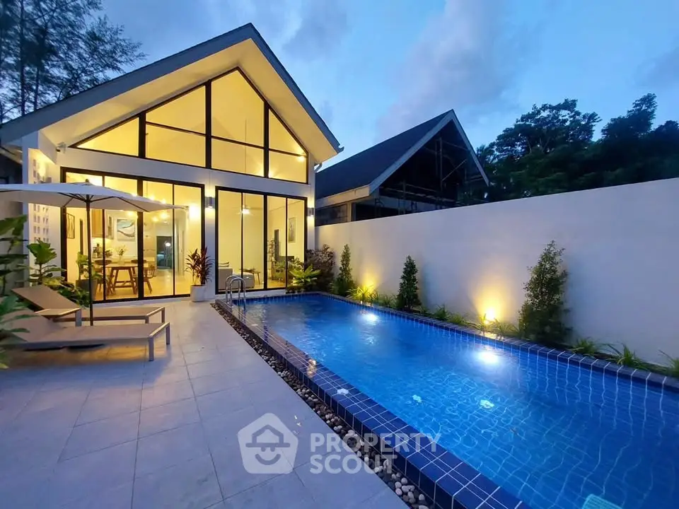 Stunning modern villa with private pool and elegant glass facade at dusk.