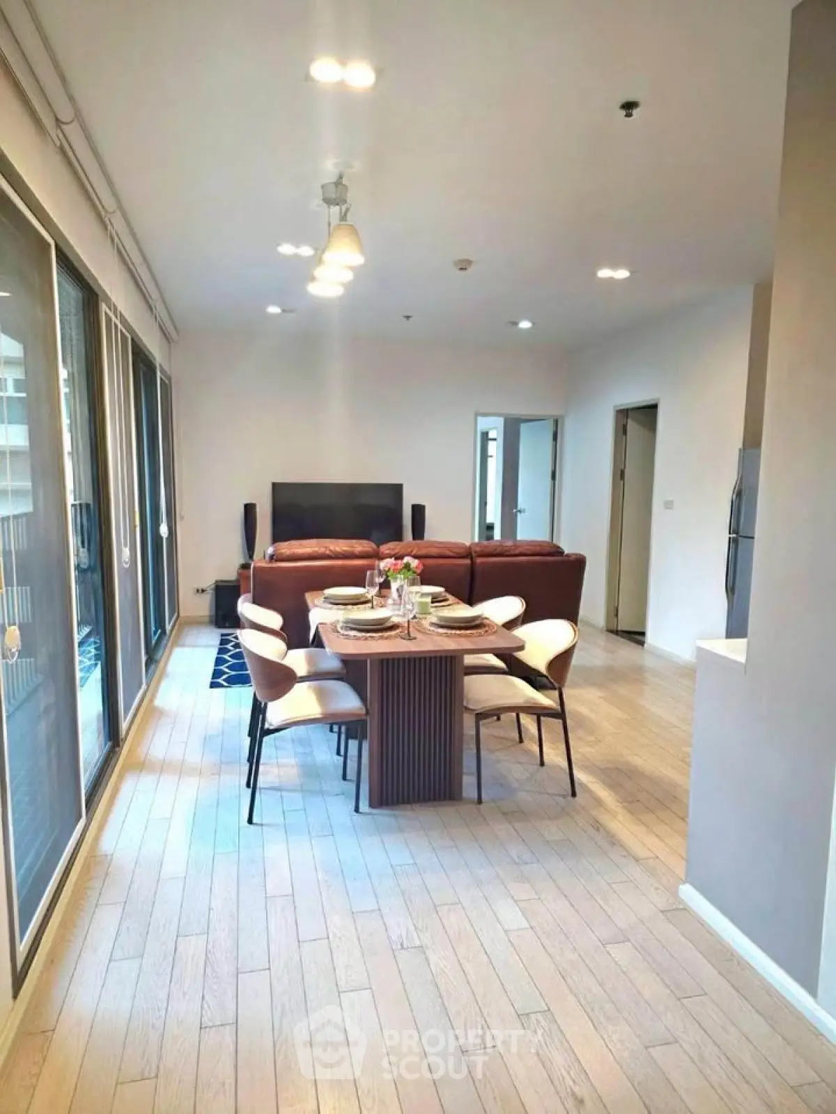 Spacious modern living room with dining area and large windows for natural light.