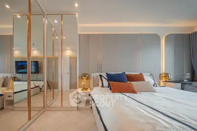 Luxurious bedroom with mirrored closet and elegant lighting