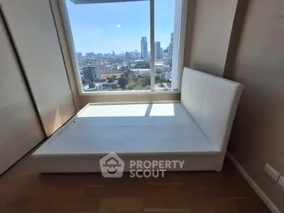 Modern bedroom with city view and sleek white bed frame
