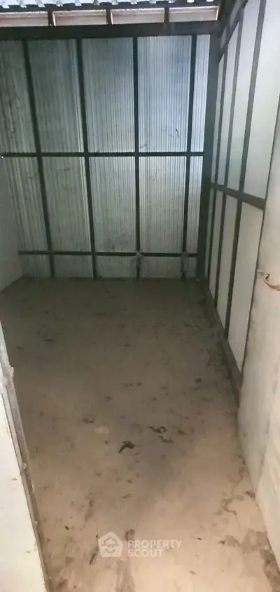 Spacious storage unit with corrugated metal walls, ideal for secure storage solutions.