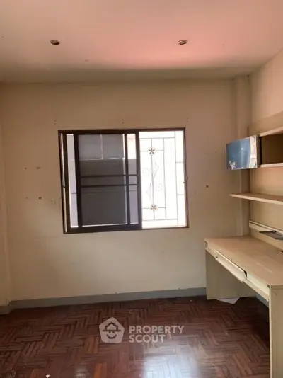 Spacious study room with built-in desk and window view