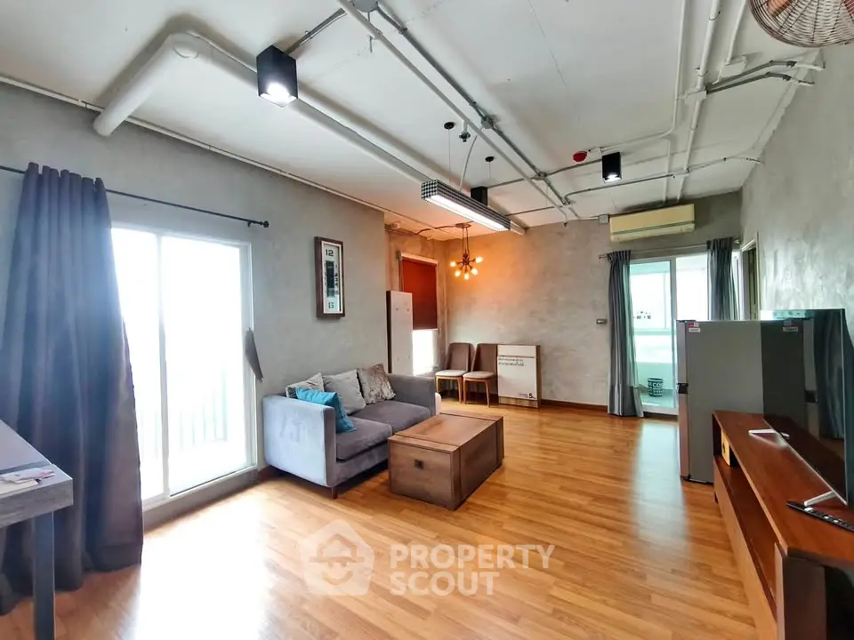 Spacious modern living room with stylish decor and large windows for natural light.