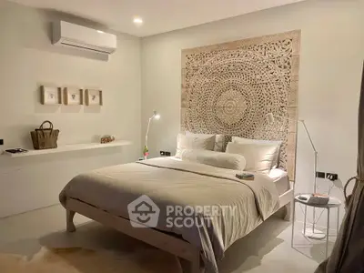 Luxurious bedroom with intricate wall art and modern lighting, perfect for relaxation and comfort.
