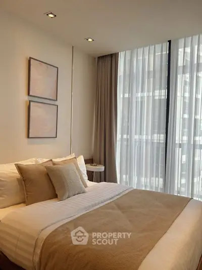 Elegant bedroom with cozy bedding and modern decor in a bright apartment