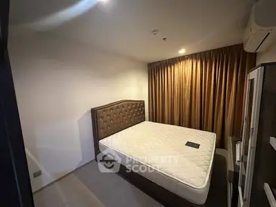 Spacious bedroom with elegant bed and warm lighting, perfect for relaxation and comfort.