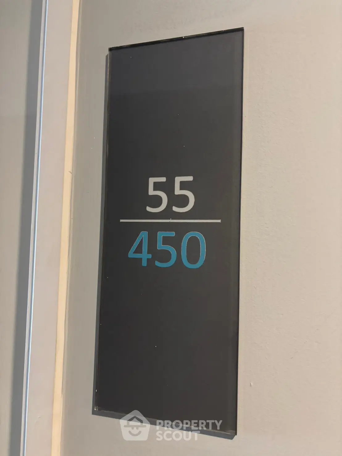Modern apartment door sign with unit number 55 and floor number 450 in sleek design.