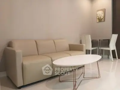 Modern living room with beige sofa and sleek white coffee table