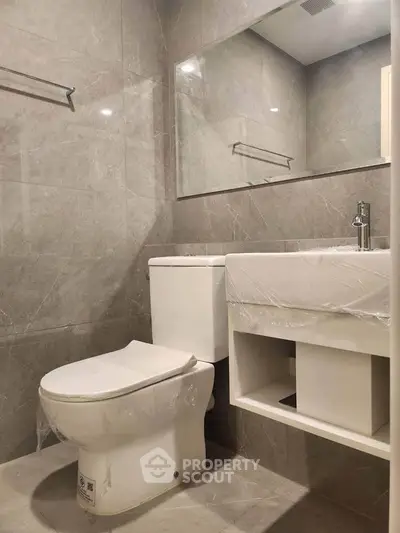Modern bathroom with sleek design and high-quality fixtures in a luxury apartment.