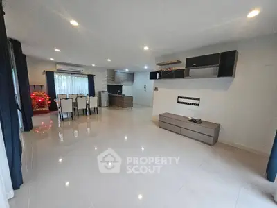 Spacious modern living room with open kitchen and elegant dining area