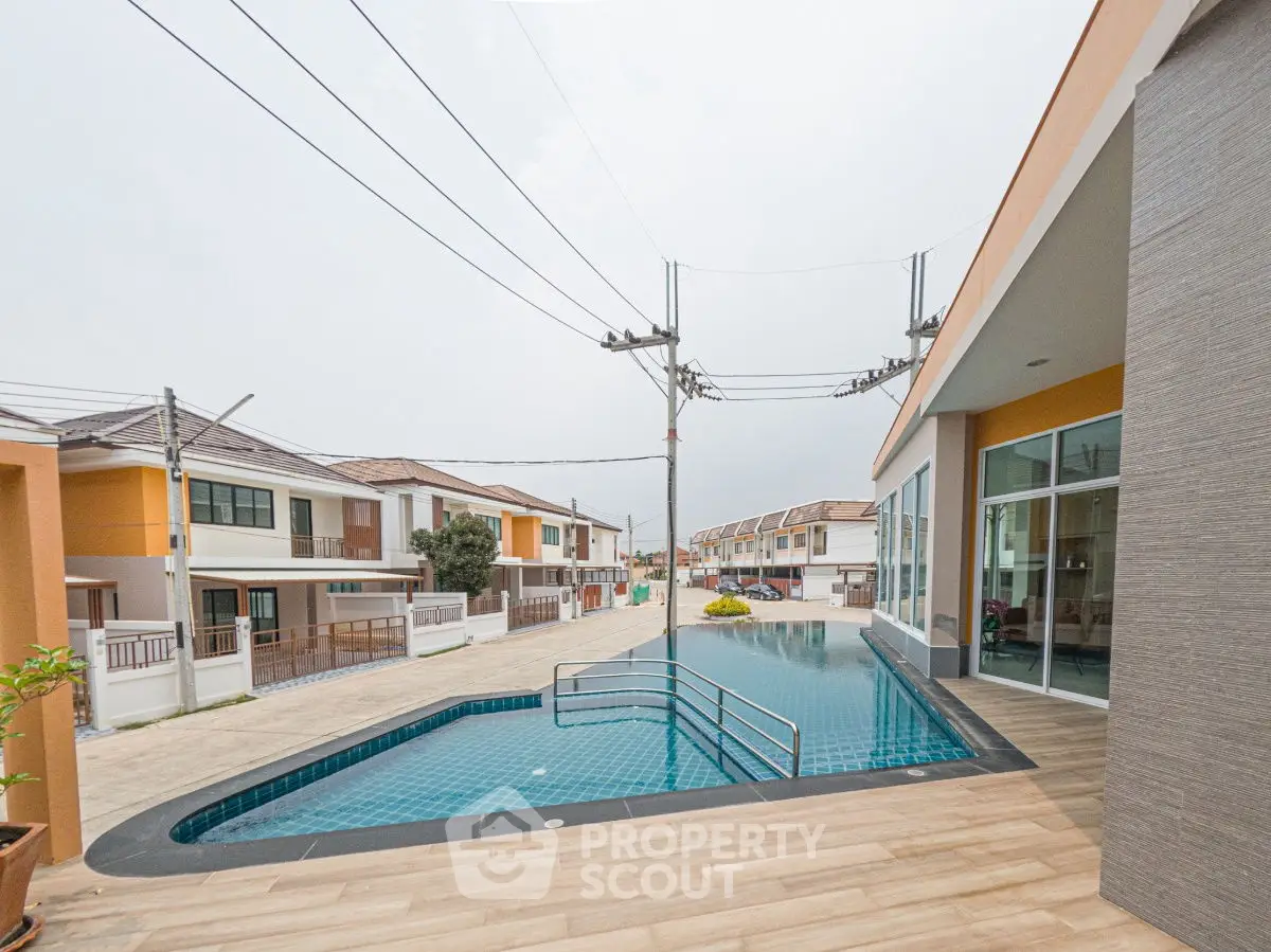 Modern residential complex with a sleek swimming pool and contemporary architecture.