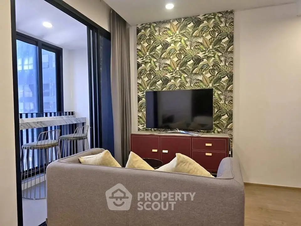 Stylish living room with modern decor and balcony view, perfect for urban living.