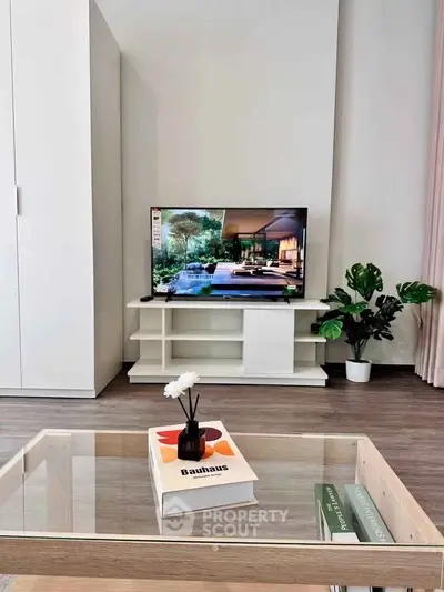 Modern living room with sleek TV setup and stylish decor, perfect for contemporary living.