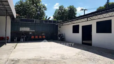 Spacious outdoor area with modern building and ample parking space