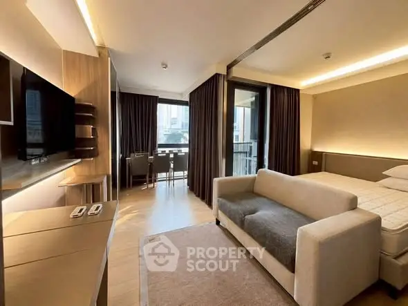 Modern studio apartment with cozy living area and balcony view