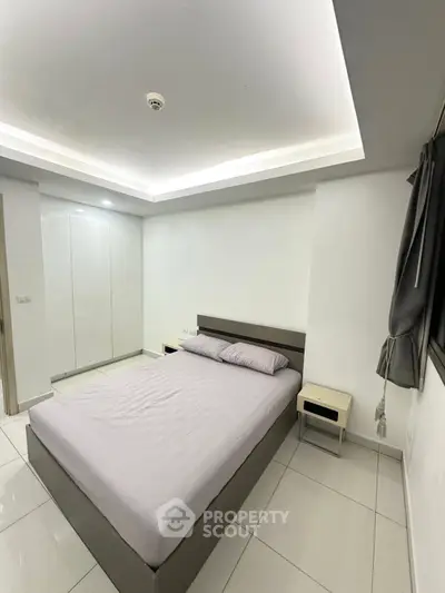 Modern minimalist bedroom with sleek design and ambient lighting