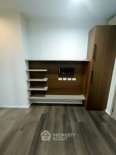 Modern living room with sleek wooden shelving and storage unit