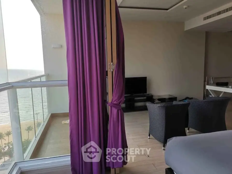 Luxurious living room with ocean view and elegant purple curtains