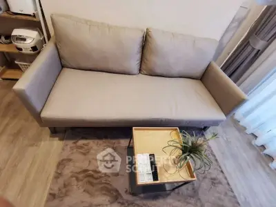 Modern living room with cozy gray sofa and stylish coffee table, perfect for relaxation and entertaining guests.