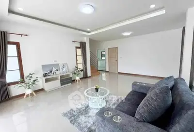 Spacious modern living room with sleek design and abundant natural light.